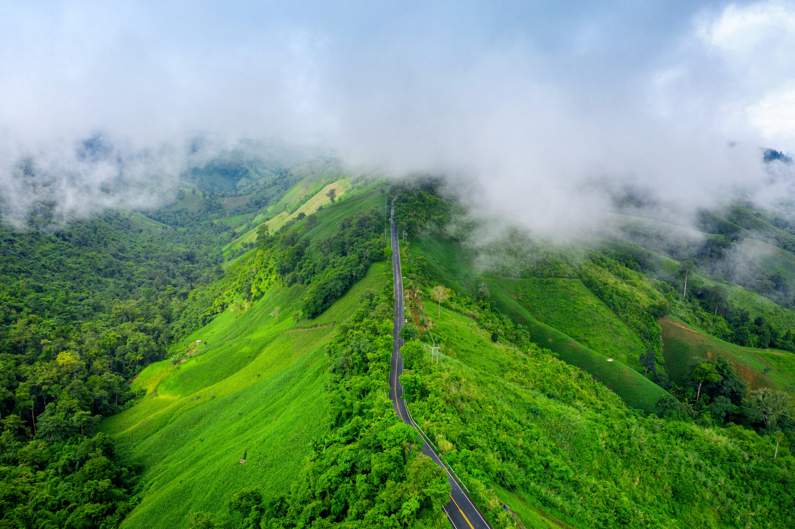 Aerial view of Beautiful sky road over top of mountains with gre